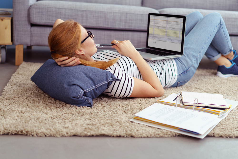 student working on homework in her living room