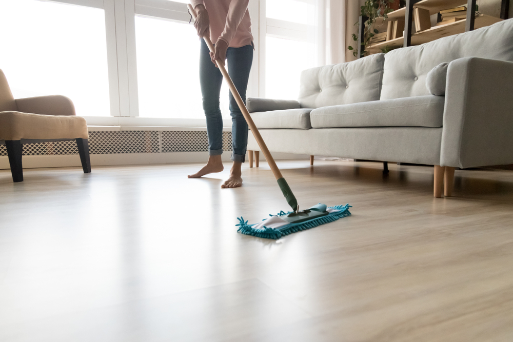 person sweeps their floors