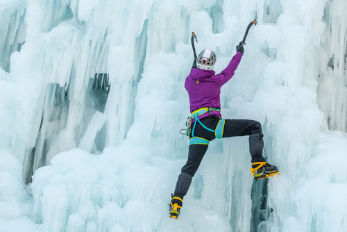woman climbs ice wall