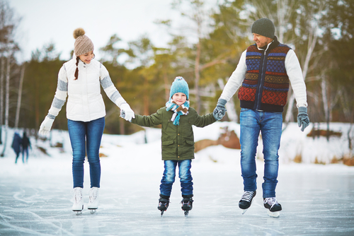 family skates on outdoor rink