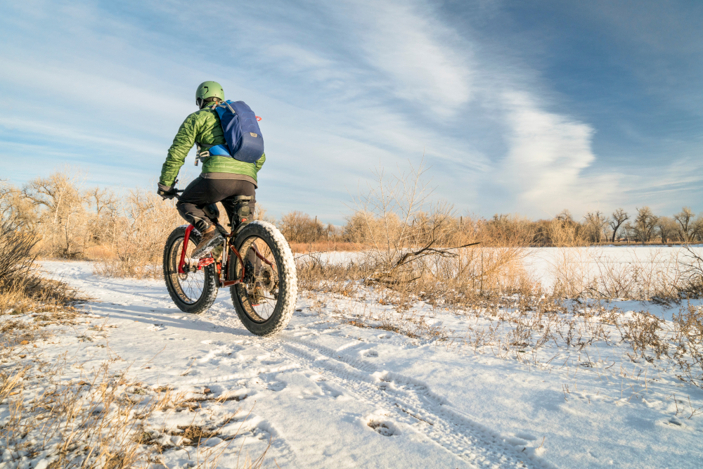 man rides fat bike on winter trail